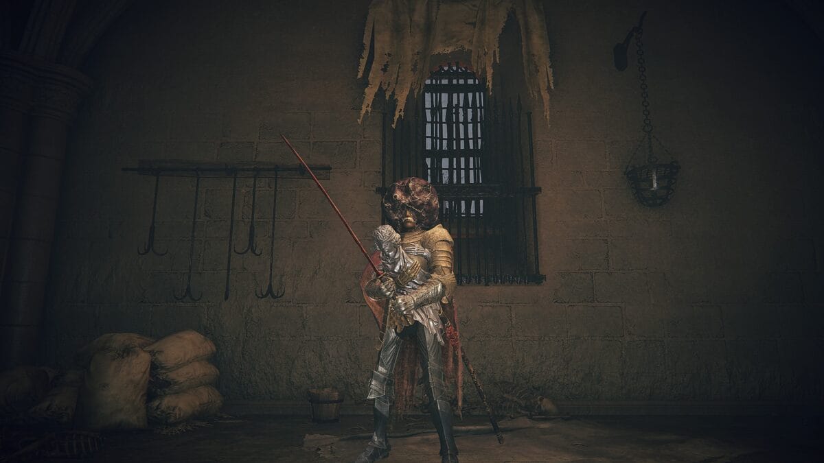 Elden Ring Black Dumpling: A player wearing the Black Dumpling standing next to a window.