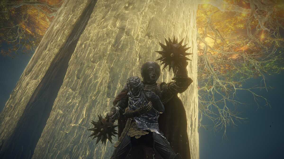 Elden Ring Star Fists: A player holding the Star Fists in the air with the Erdtree in the background.