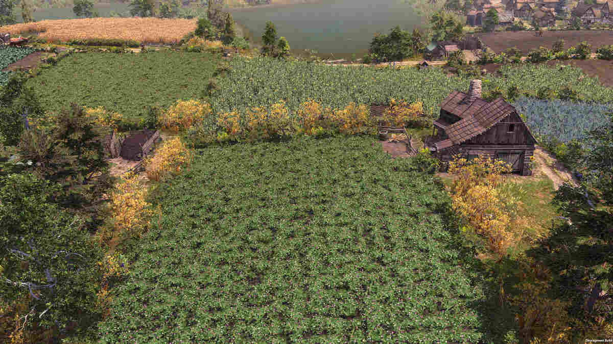 Aerial view of a rural landscape with a log cabin surrounded by various crop fields and trees in Farthest Frontier