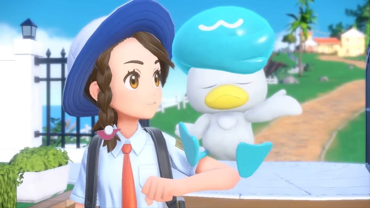 Games like Pokemon: A player holding a Quaxly on their arm.