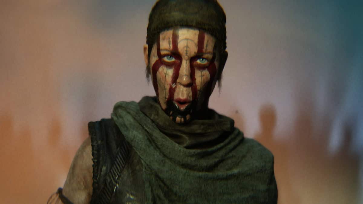 Screenshot from Hellblade 2 showing protagonist Senua grimacing at the camer.a