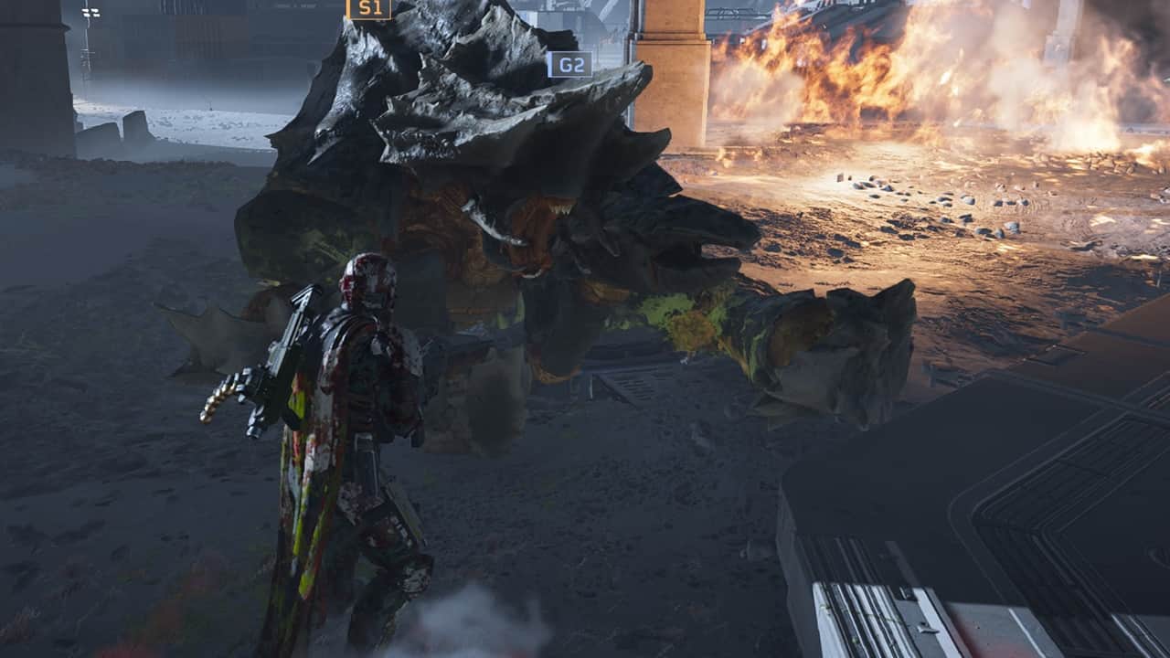Helldivers 2 best loadouts: A player looks at a dead Charger in the game. Image captured by VideoGamer.