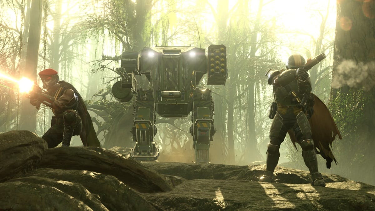 Players stand near a mech and fire weapons in Helldivers 2.