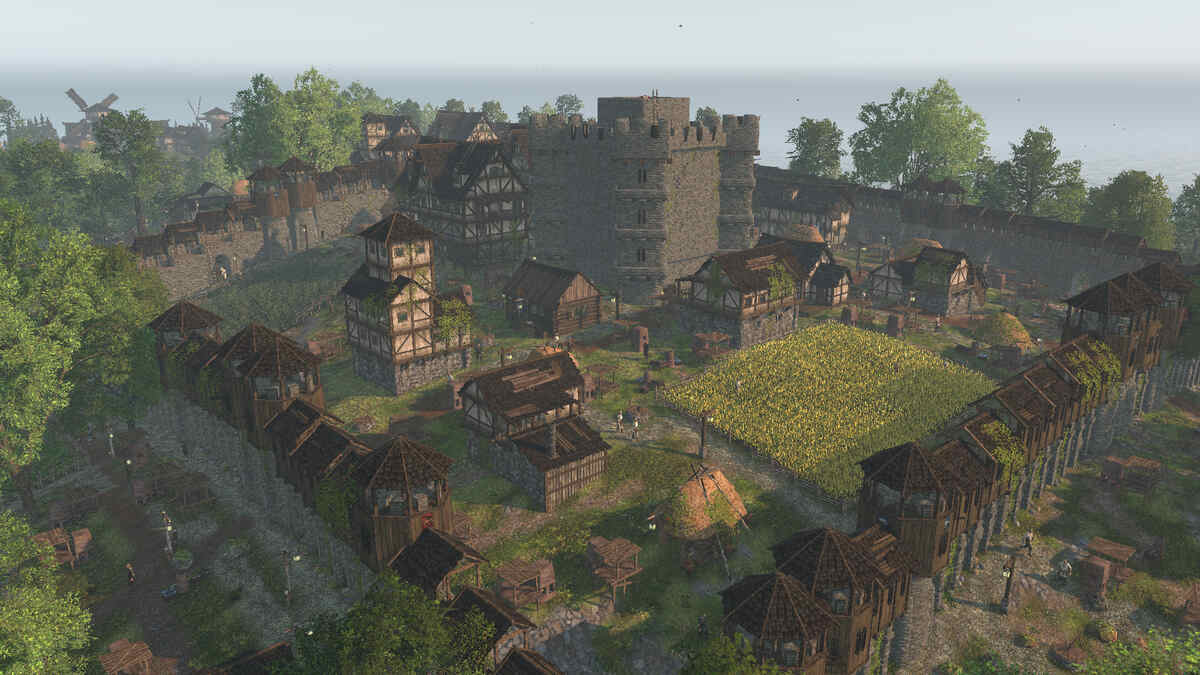 A medieval-style village with stone walls, timber houses, a central fortified tower in Life is Feudal Forest Village