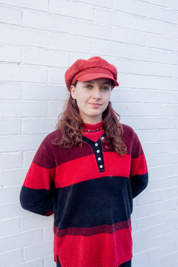A woman wearing a red striped sweater.
