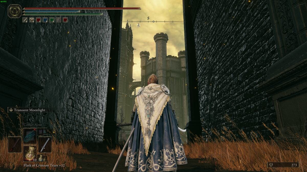 Elden Ring Shadow of the Erdtree review: Tarnished standing at a large door way with a castle in the distance.