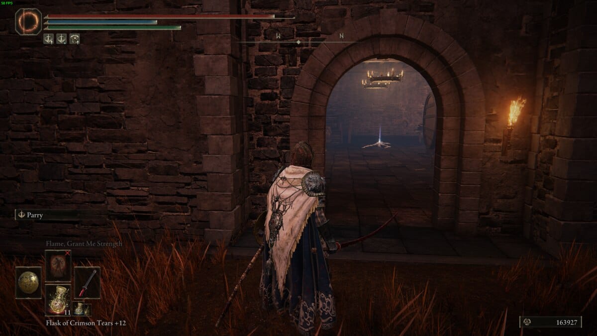 Elden Ring Shadow of the Erdtree talisman: tarnished entering a building below Castle Ensis.