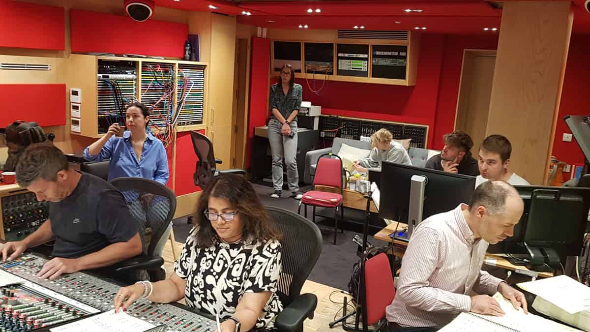 A control room where people are working on a game's soundtrack.